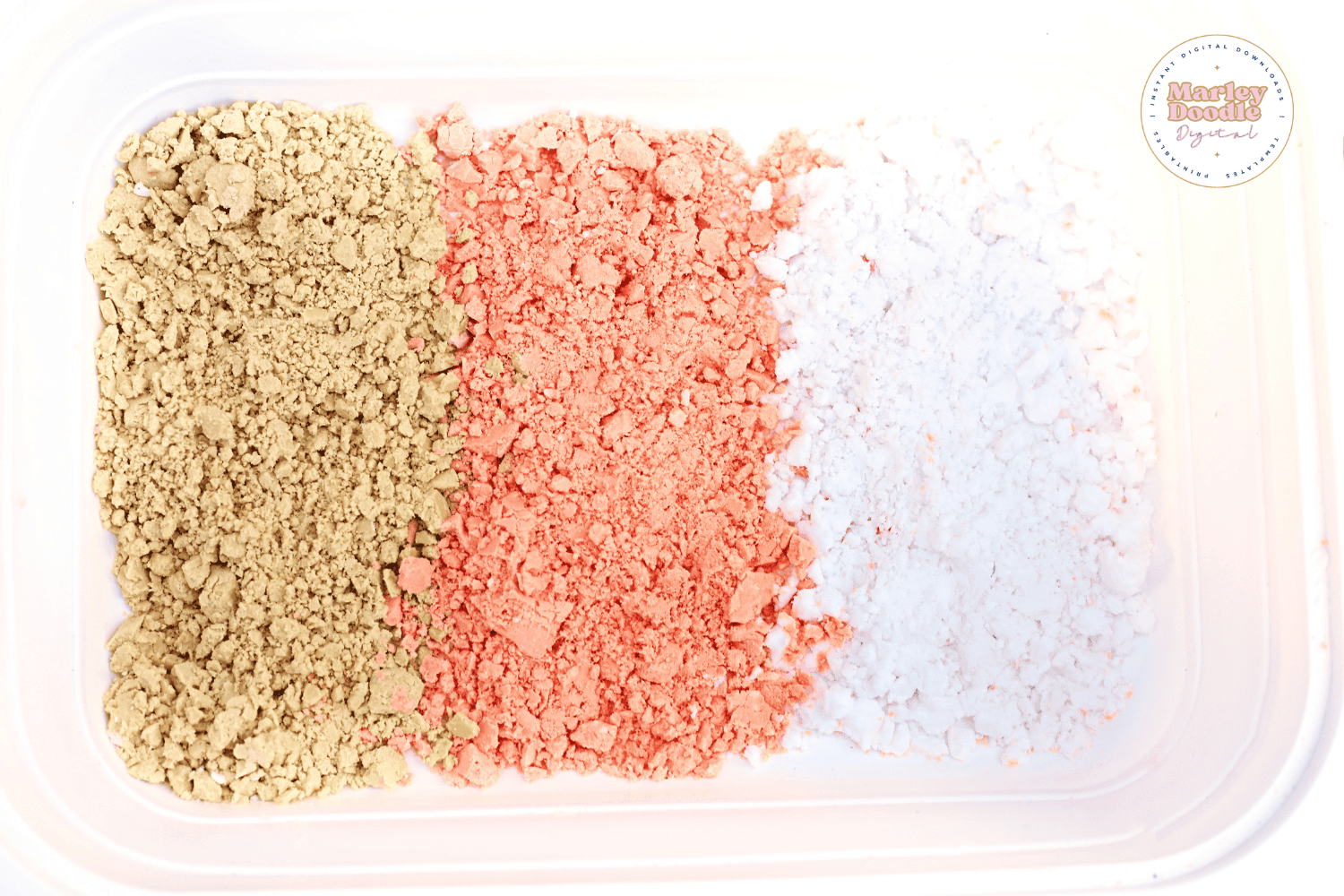 Cloud dough in ice cream colors arranged in a sensory bin.