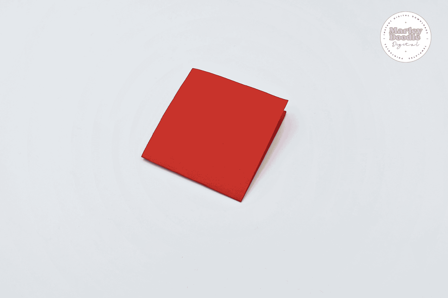 Folded red paper square for boat sail craft.