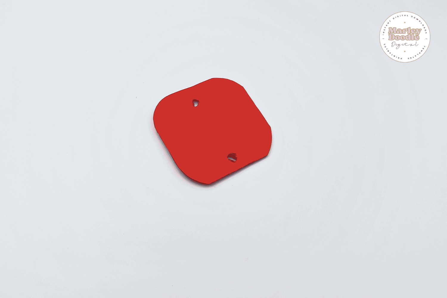 Red paper with rounded corners and punched holes.