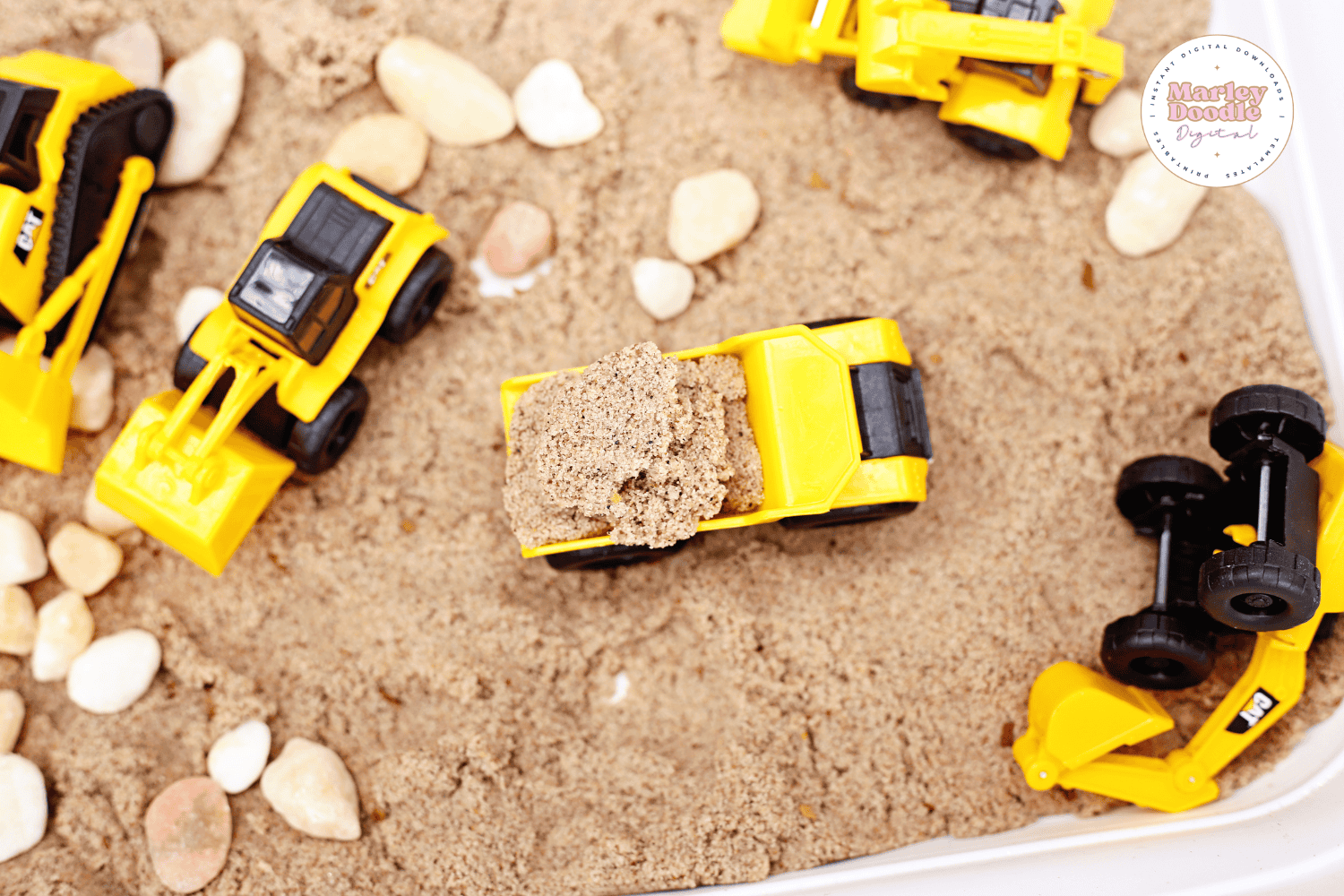 Dump truck filled with kinetic sand in sensory bin play.