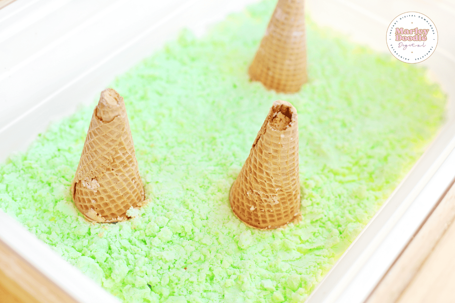 Volcano cones placed in green sensory bin base.