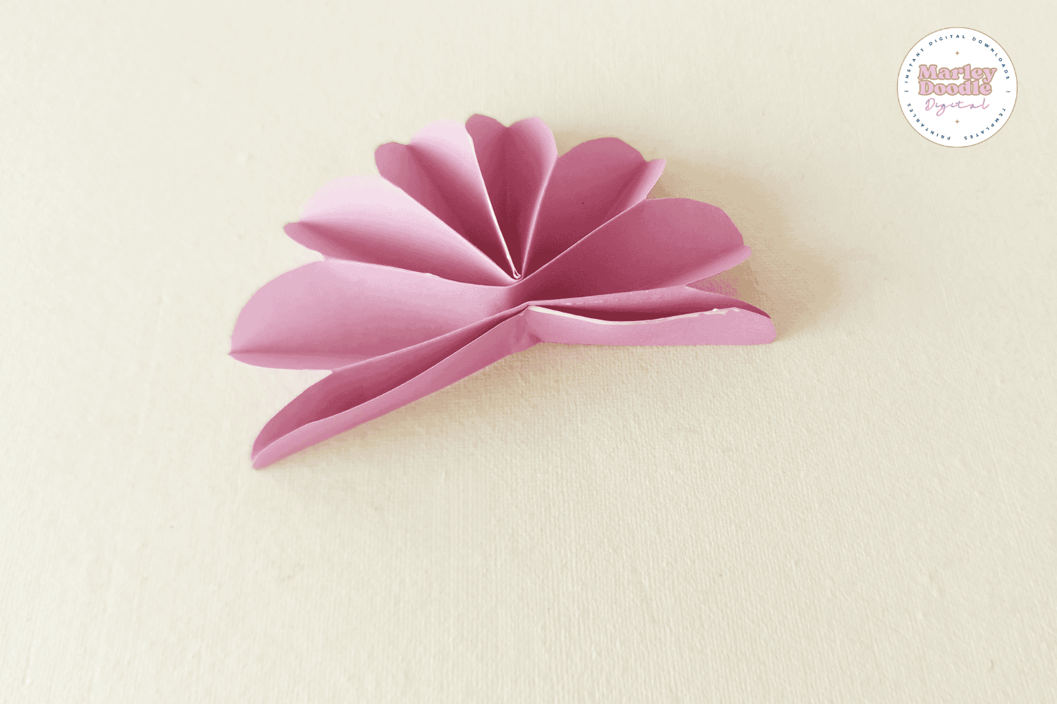 Joining paper petals to form full paper flower.