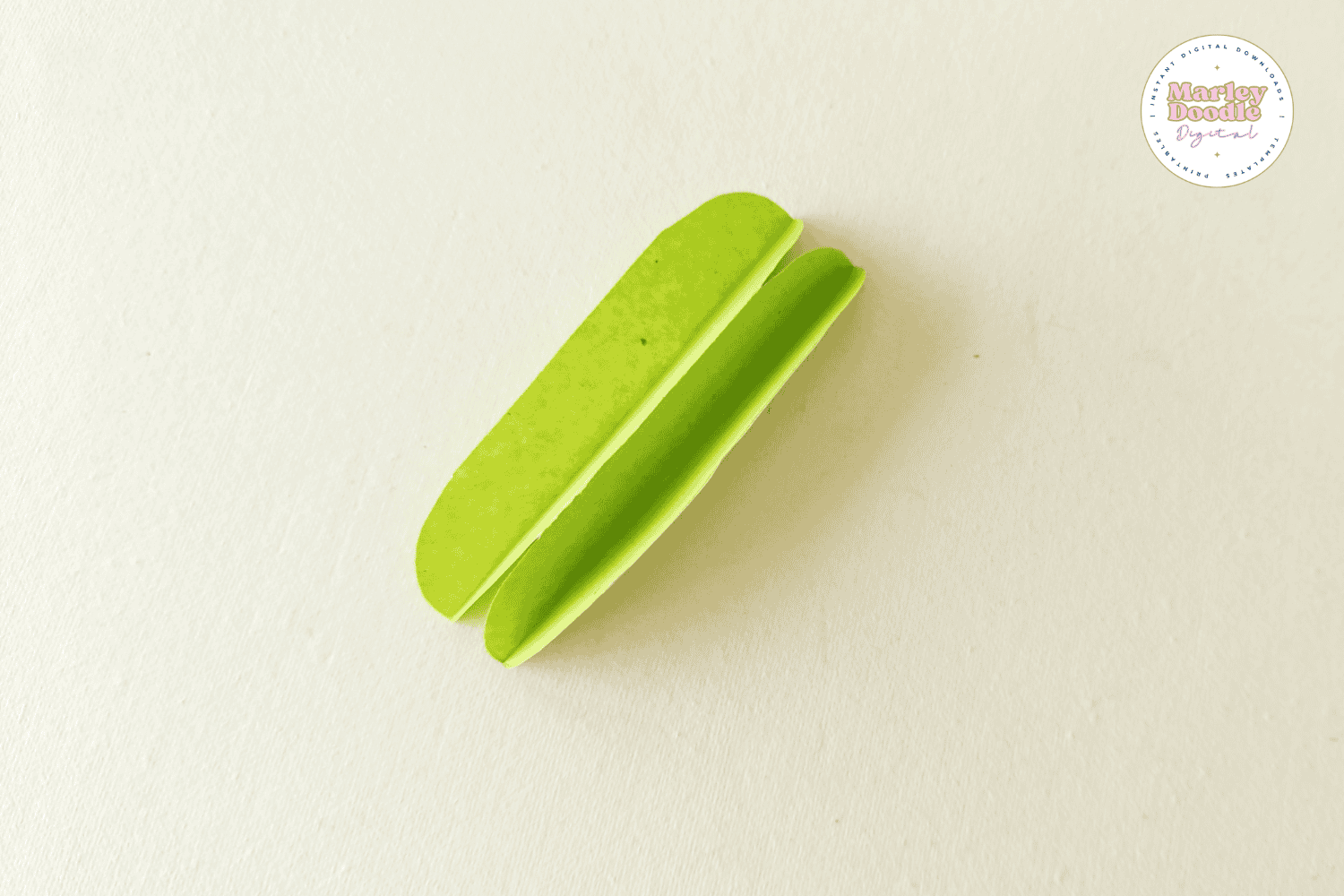 Folded green paper leaf for paper flower wreath.