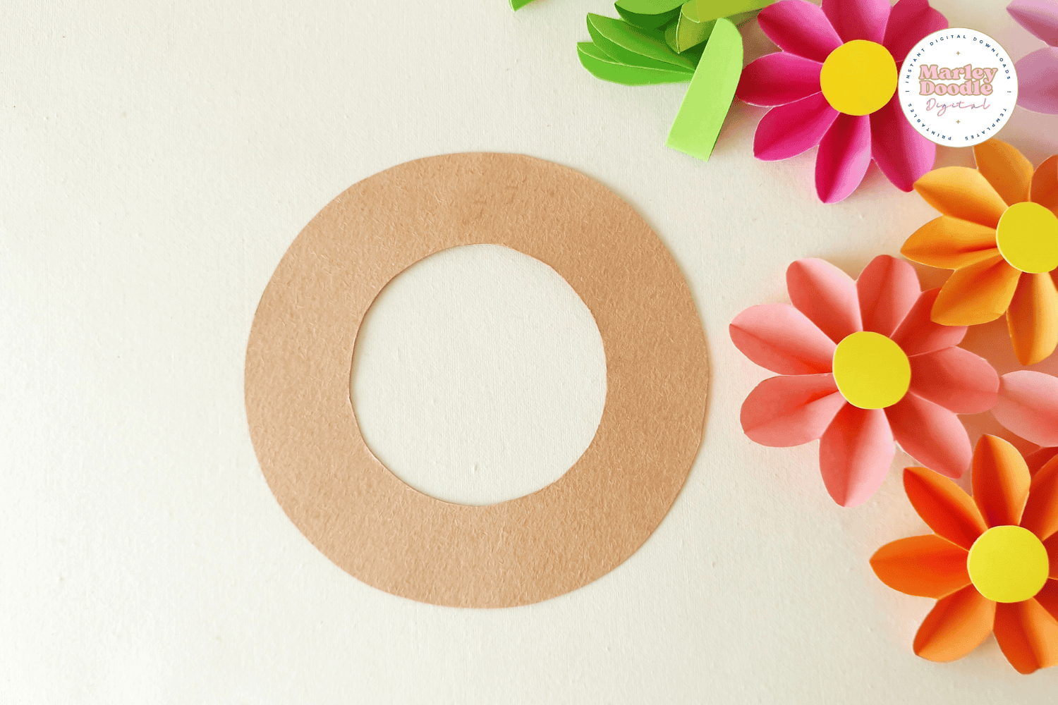 Brown paper wreath base and paper flowers.