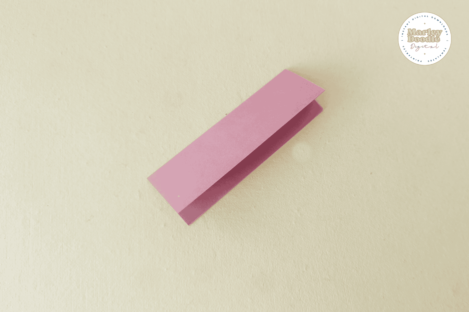 Folded pink paper strip for paper flower petal.