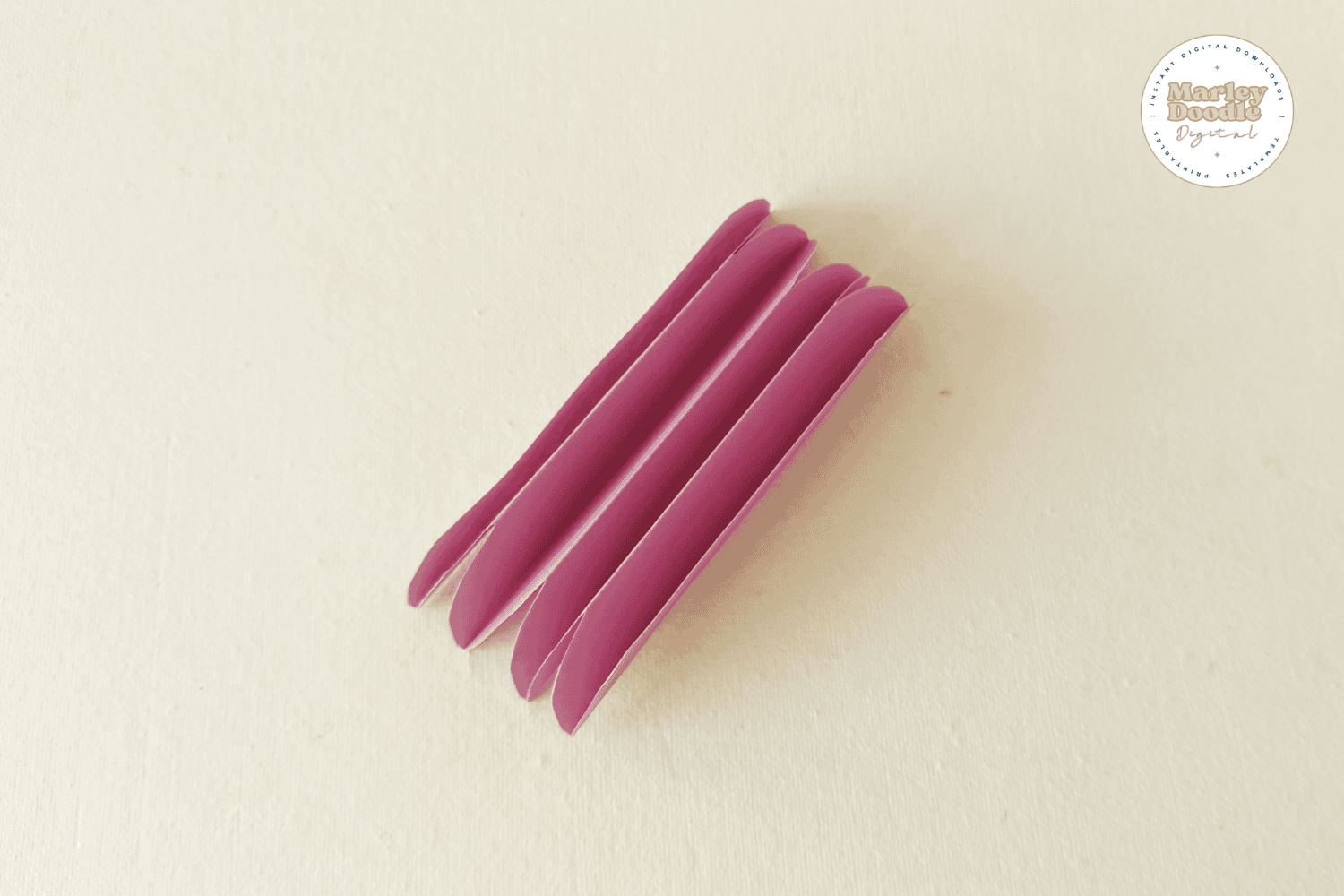 Multiple pink paper petals folded accordion style.