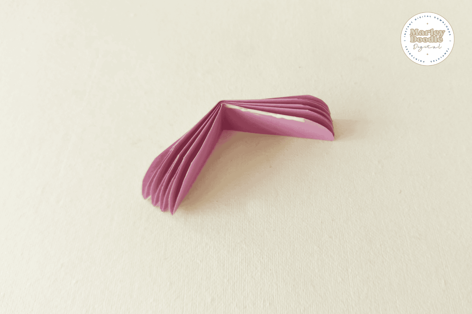 Glue folded paper petals to create flower half.