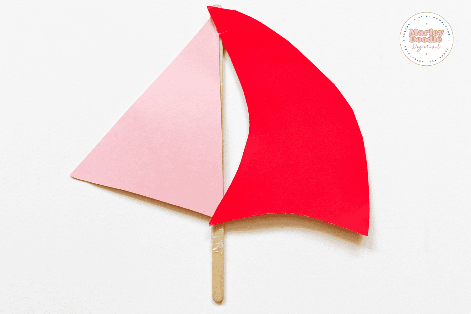 Two paper sails assembled for rocking boat craft.