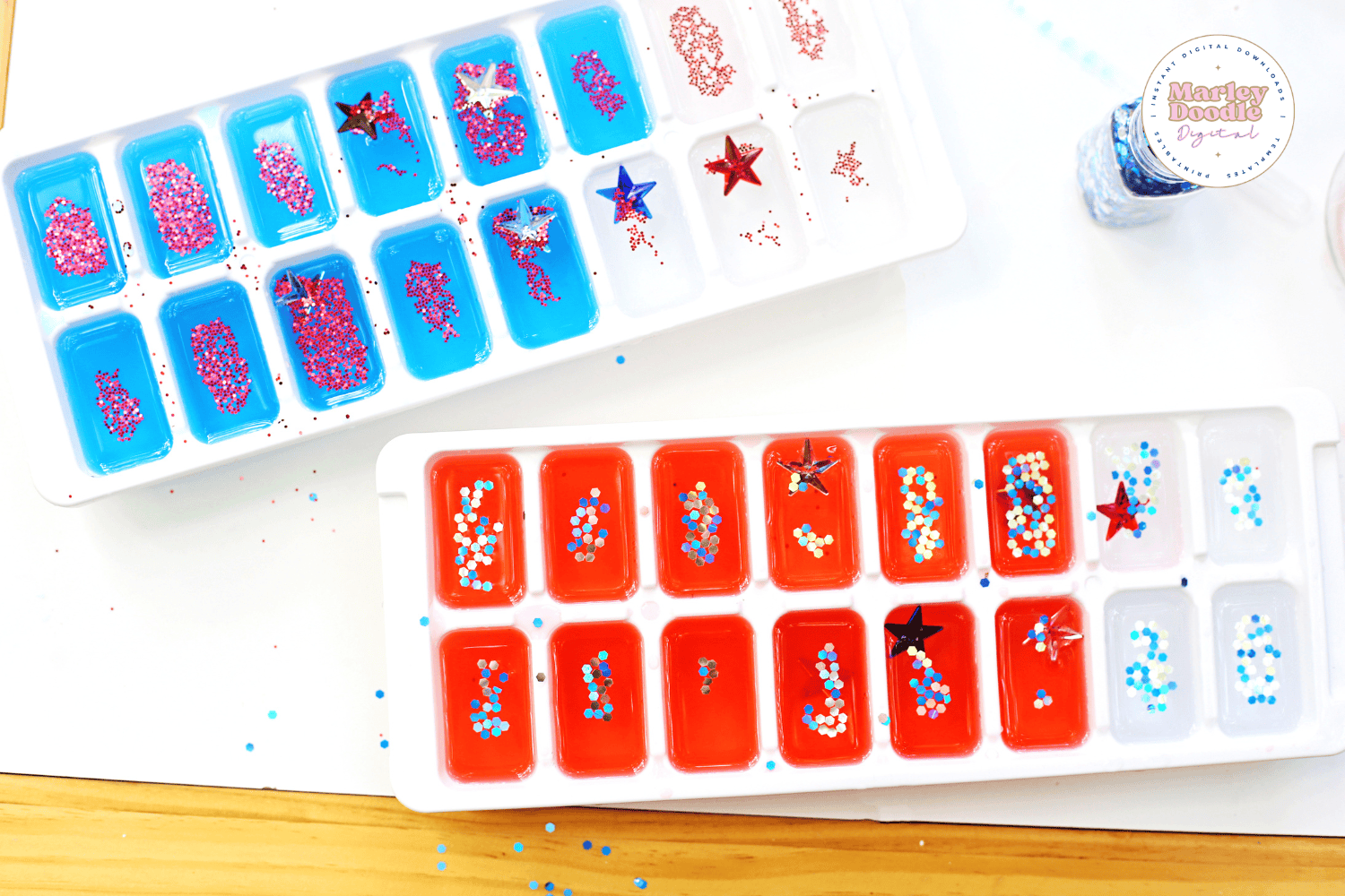 Ice cube trays with red, white, and blue water and glitter stars
