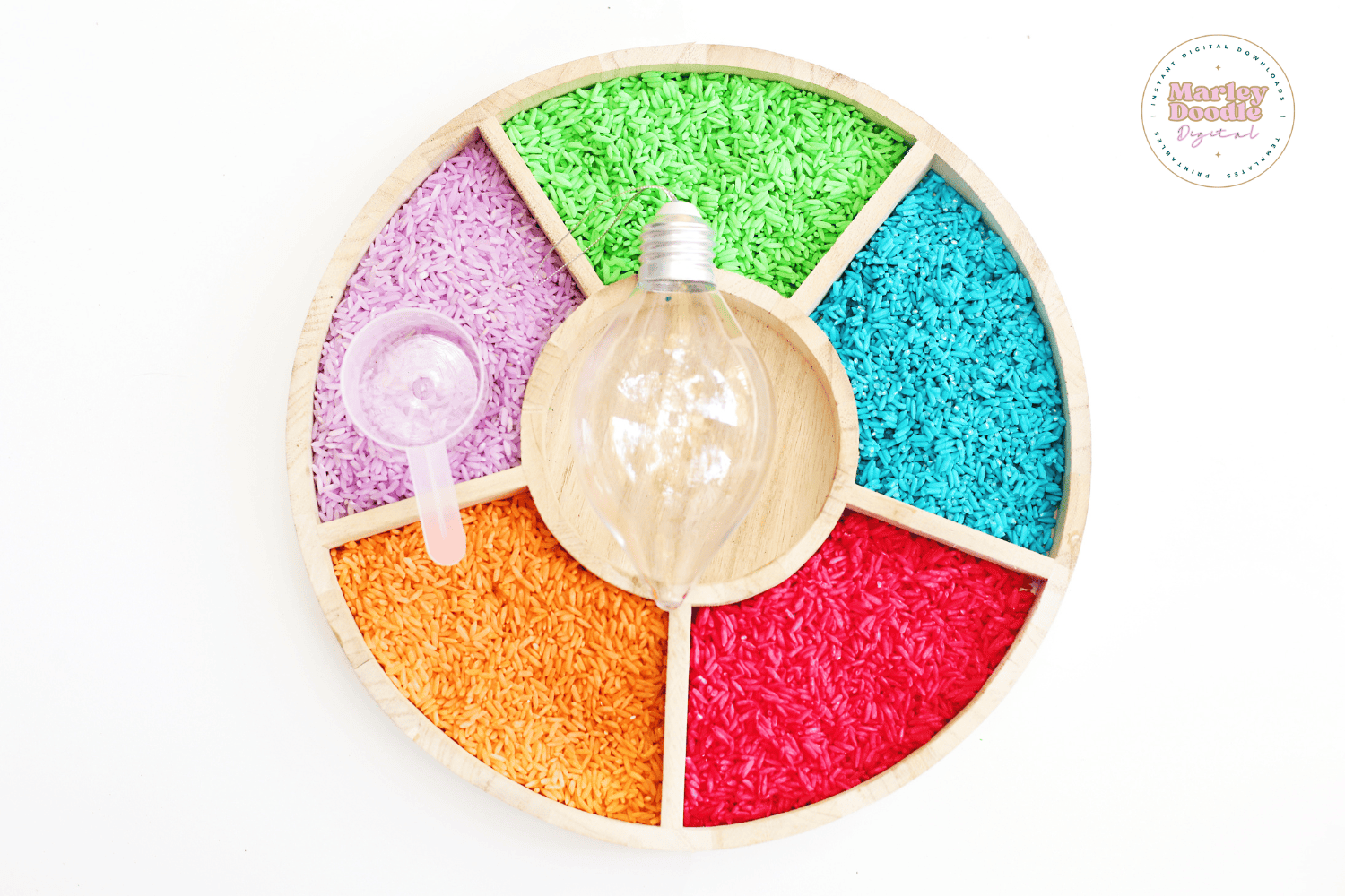 Empty clear light bulb ornament with rainbow rice sensory tray